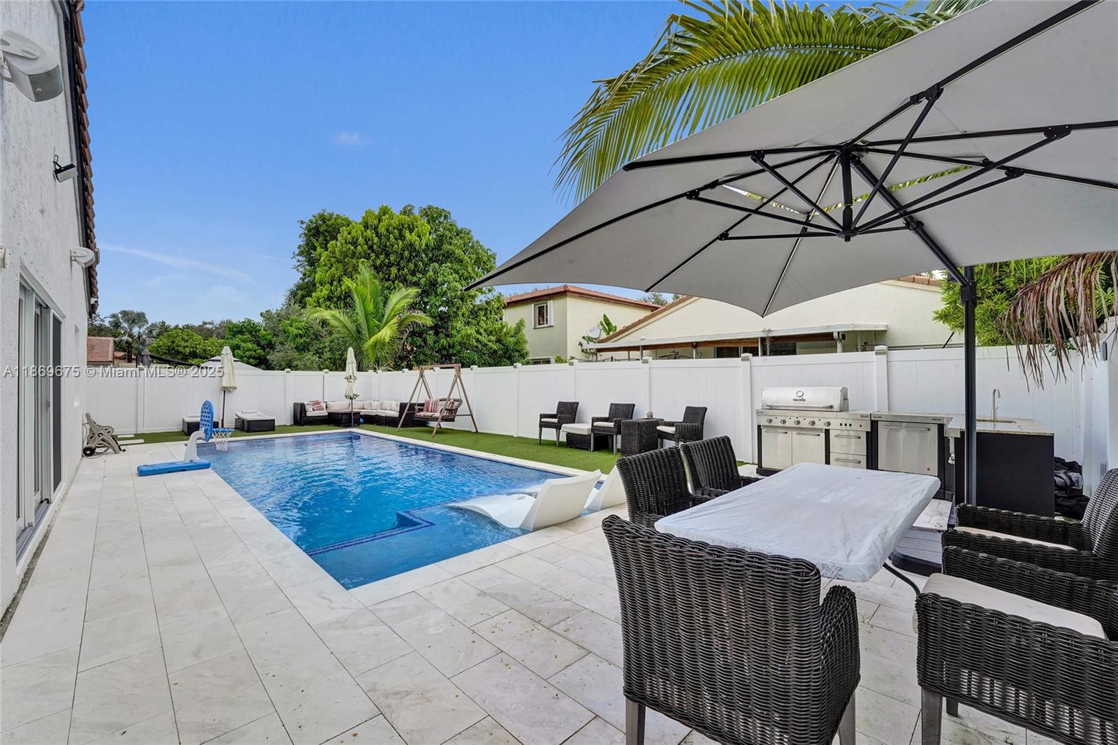 1636 Southwest 108th Terrace Davie, FL 33324 - Photo 66 of 92 a view of a patio with a table and chairs under an umbrella