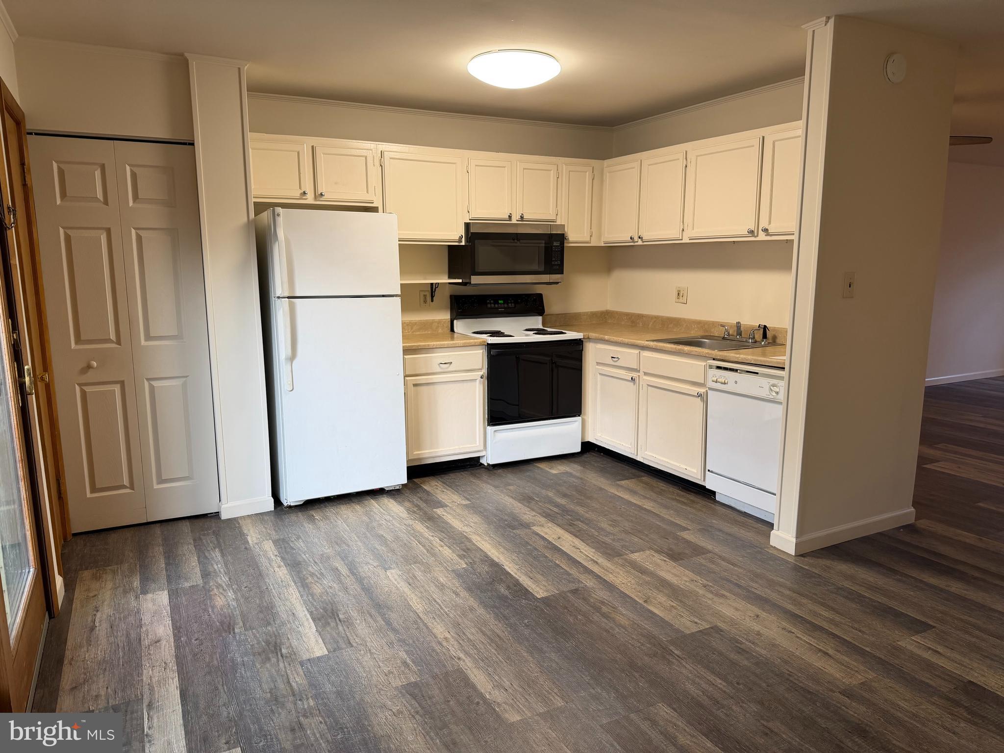 548 Lopax Road Harrisburg, PA 17112 - Photo 16 of 46 a kitchen with a refrigerator stove and wooden cabinets