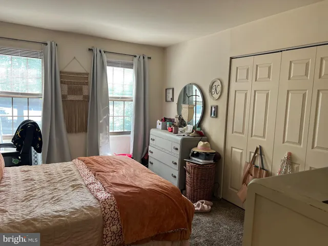 a bedroom with a bed and flat screen tv
