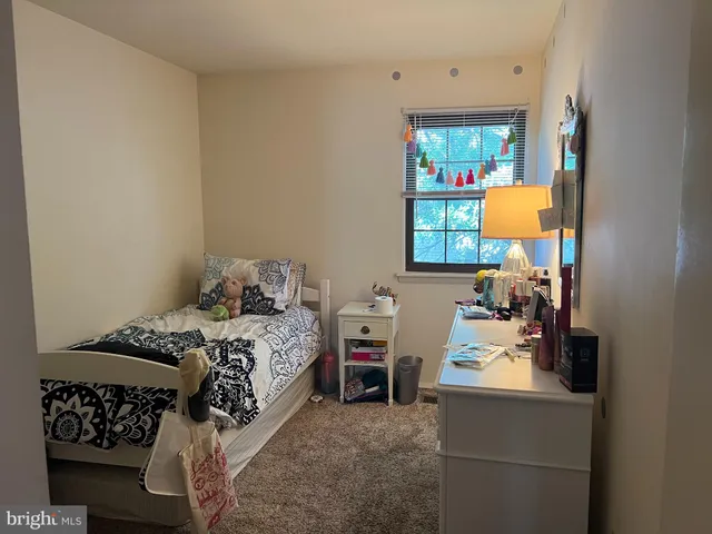 a bedroom with a bed and a mirror