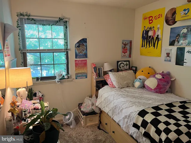 a bedroom with a bed and a window