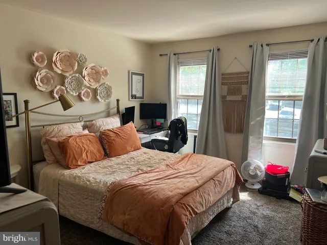 a bedroom with a bed and flat screen tv