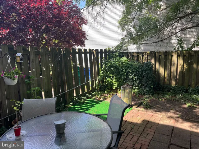 a view of a chairs and table in backyard