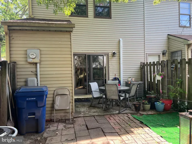 a view of a patio with table and chairs and potted plants