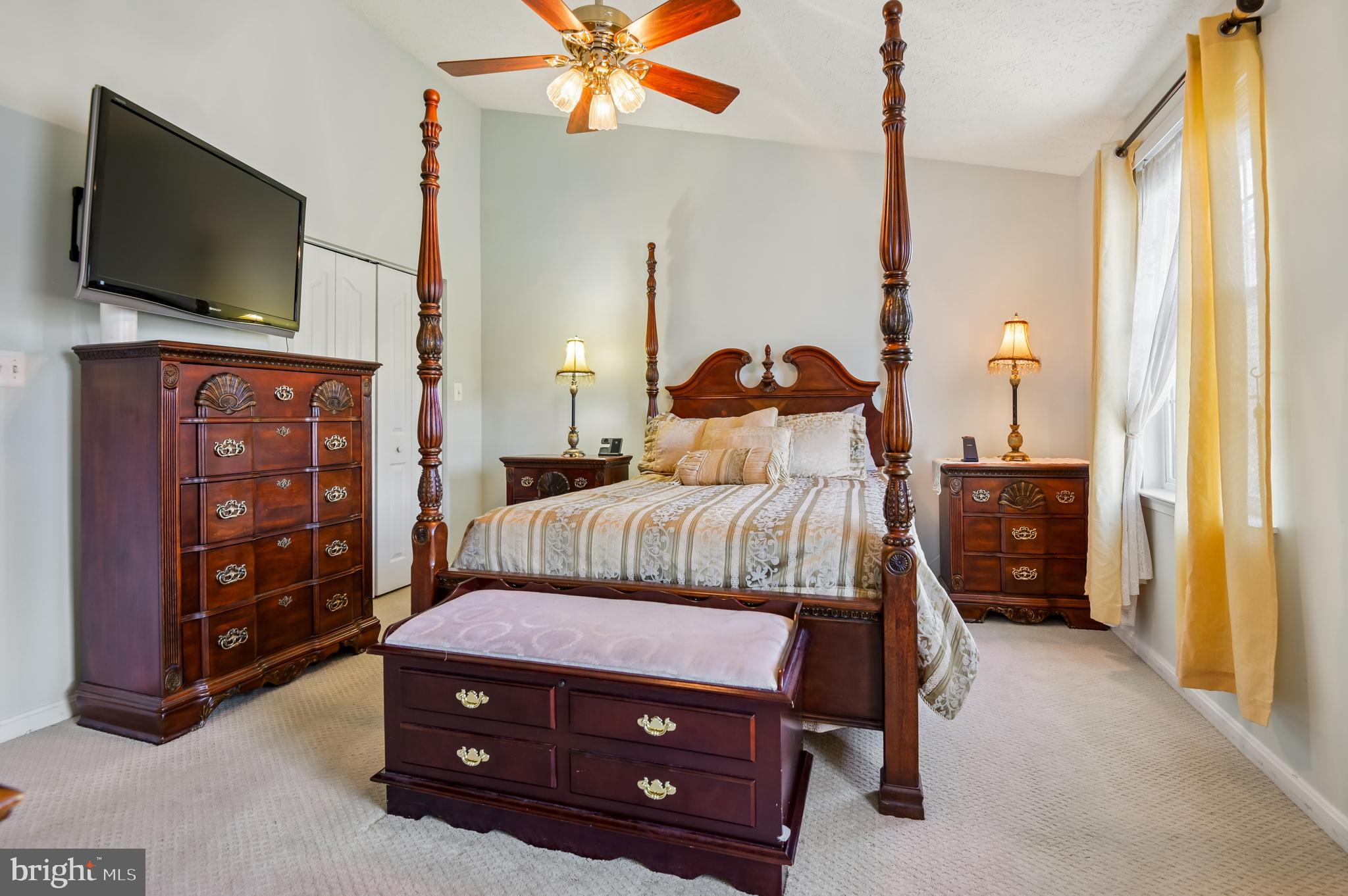 479 Manor Road Aberdeen, MD 21001 - Photo 24 of 36 a bedroom with a bed a flat screen tv and a chandelier