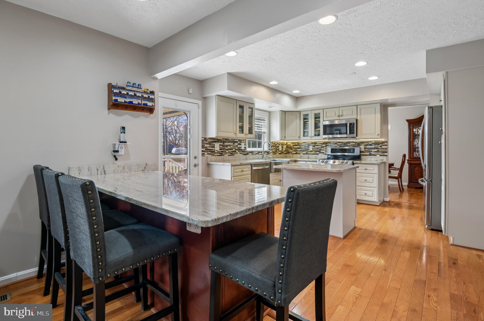 479 Manor Road Aberdeen, MD 21001 - Photo 9 of 36 a kitchen with kitchen island a dining table and chairs