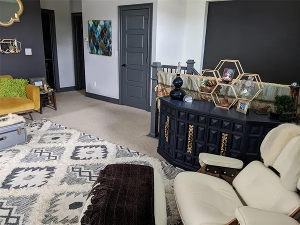 a view of a bedroom with furniture