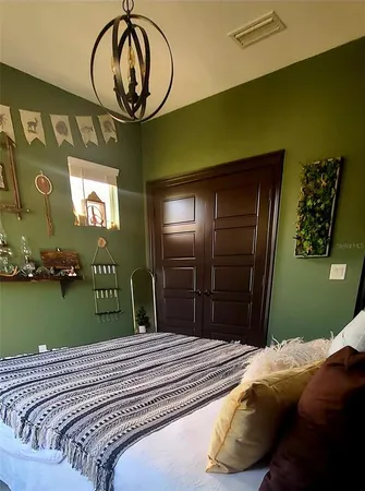 a bedroom with a bed and cabinets