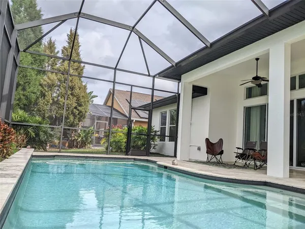 a view of swimming pool with outdoor seating