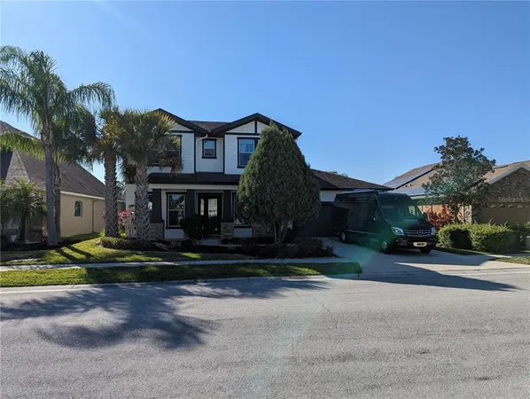 a view of a lake with a yard and large trees