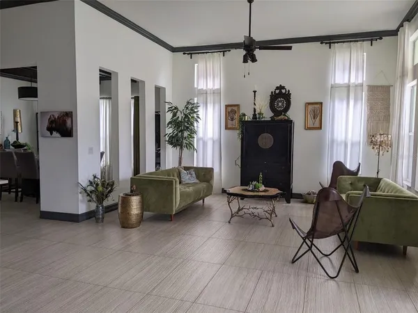 a living room with furniture and a chandelier