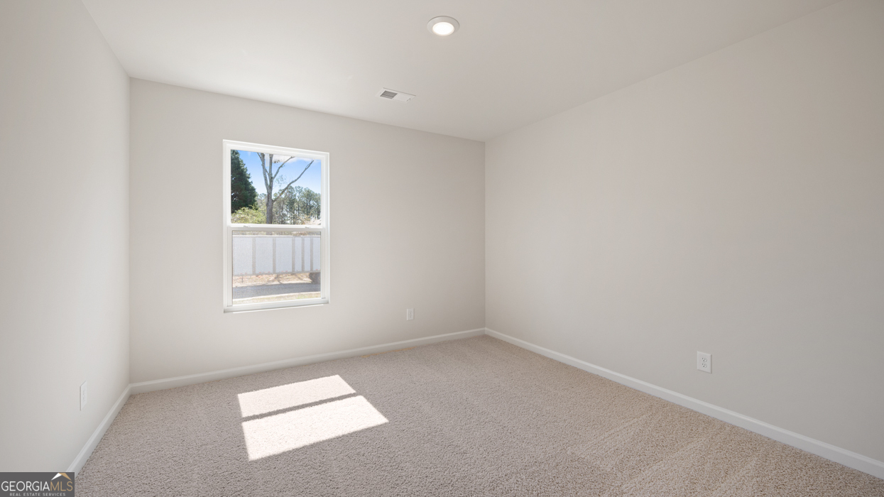 8578 Seabiscuit Road Lithonia, GA 30058 - Photo 21 of 30 an empty room with a window
