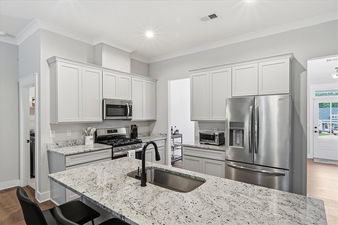 214 Timothy Court Anderson, SC 29621 - Photo 10 of 43 A well-appointed kitchen features ample counter space, stainless steel appliances, and sleek cabinetry.