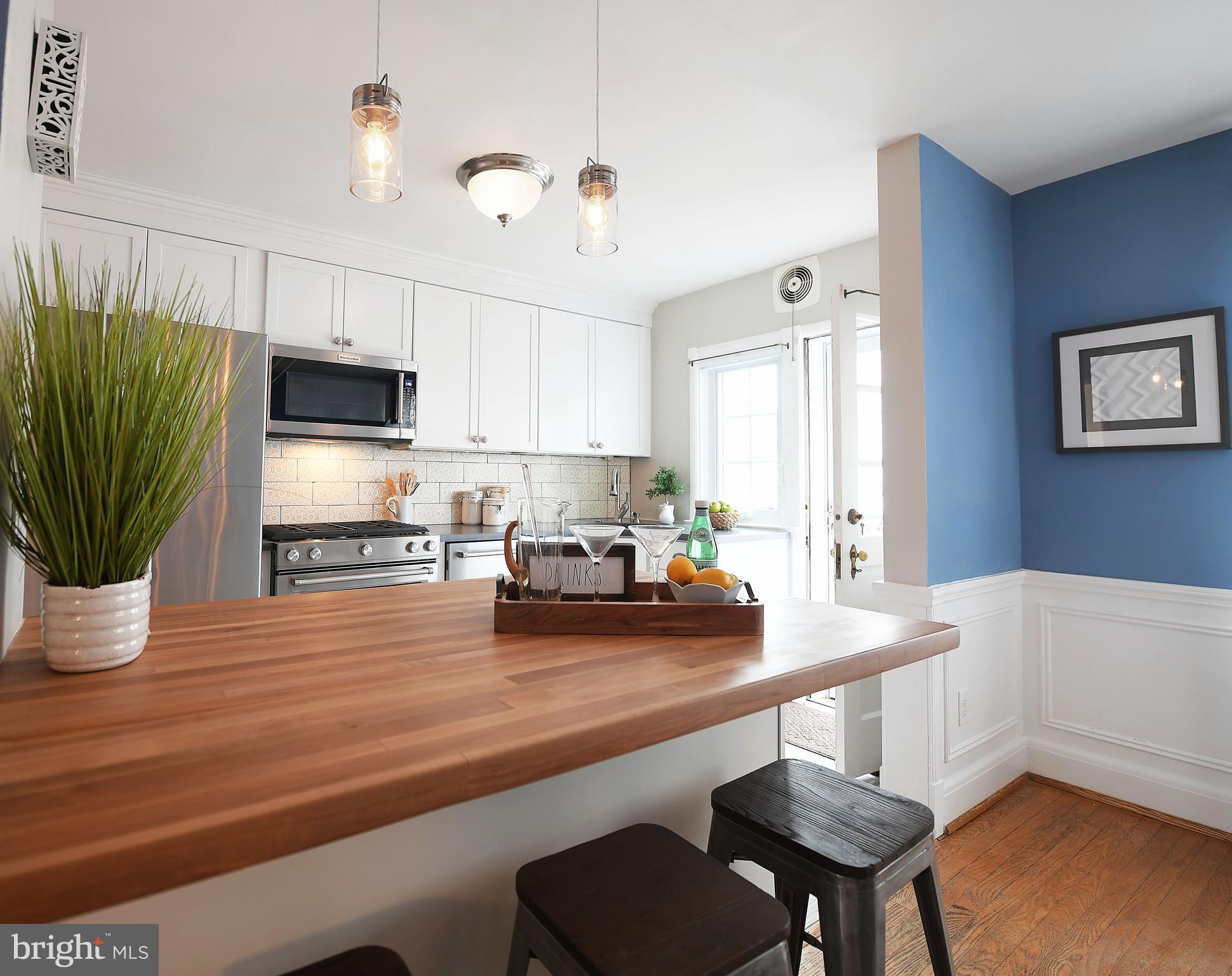 5 Murdock Road Baltimore, MD 21212 - Photo 11 of 48 a kitchen with a table chairs and microwave