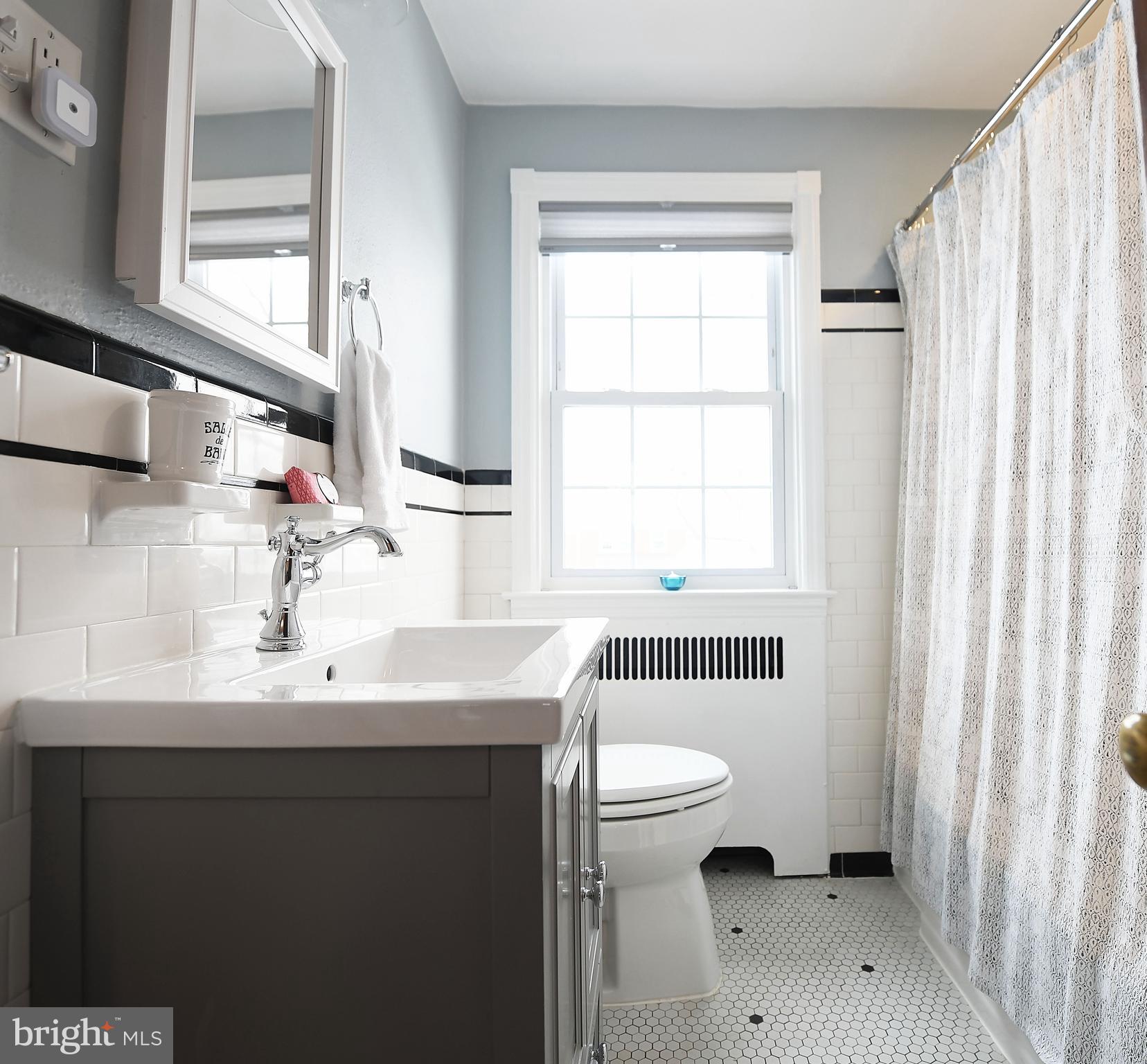 5 Murdock Road Baltimore, MD 21212 - Photo 21 of 48 a bathroom with a sink toilet a mirror and shower