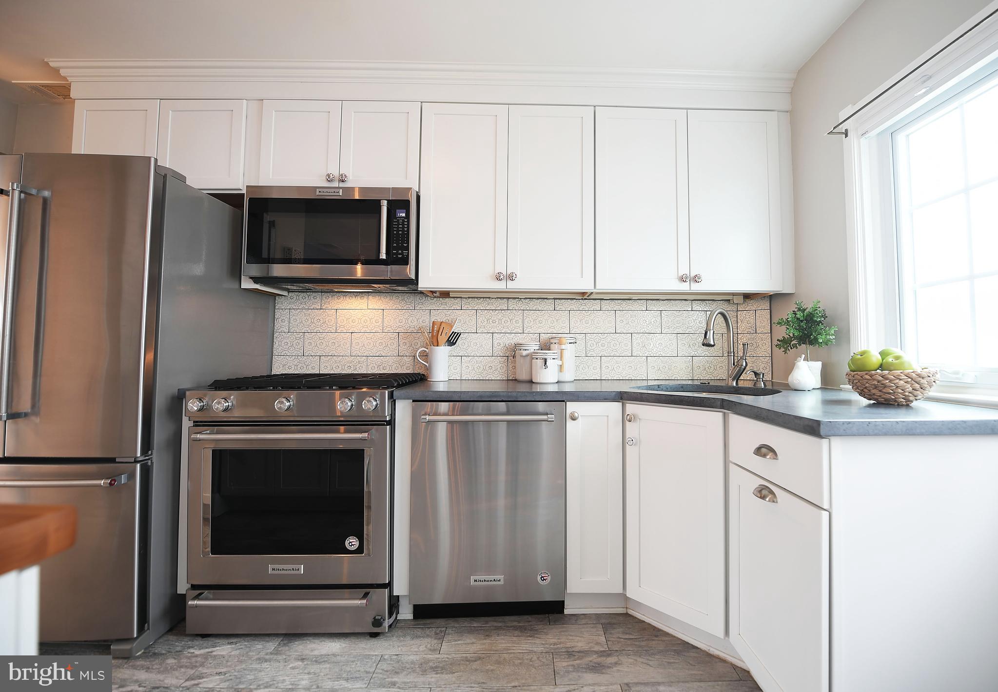 5 Murdock Road Baltimore, MD 21212 - Photo 10 of 48 a kitchen with white cabinets and stainless steel appliances