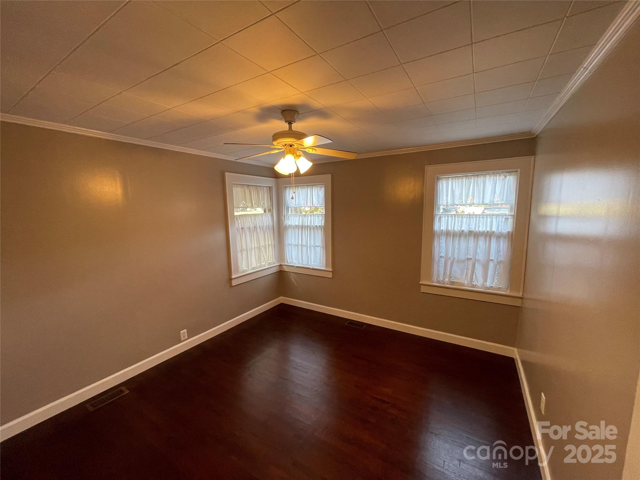 2711 Mooresville Road Salisbury, NC 28147 - Photo 14 of 18 an empty room with wooden floor and windows