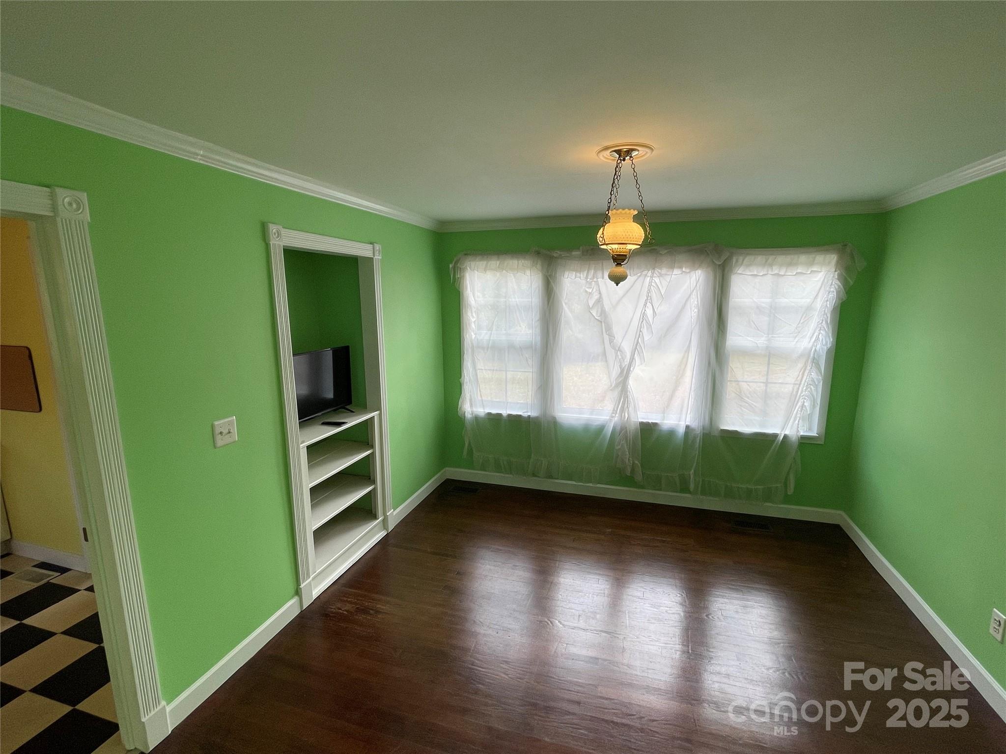 2711 Mooresville Road Salisbury, NC 28147 - Photo 4 of 18 a view of empty room with wooden floor and fan