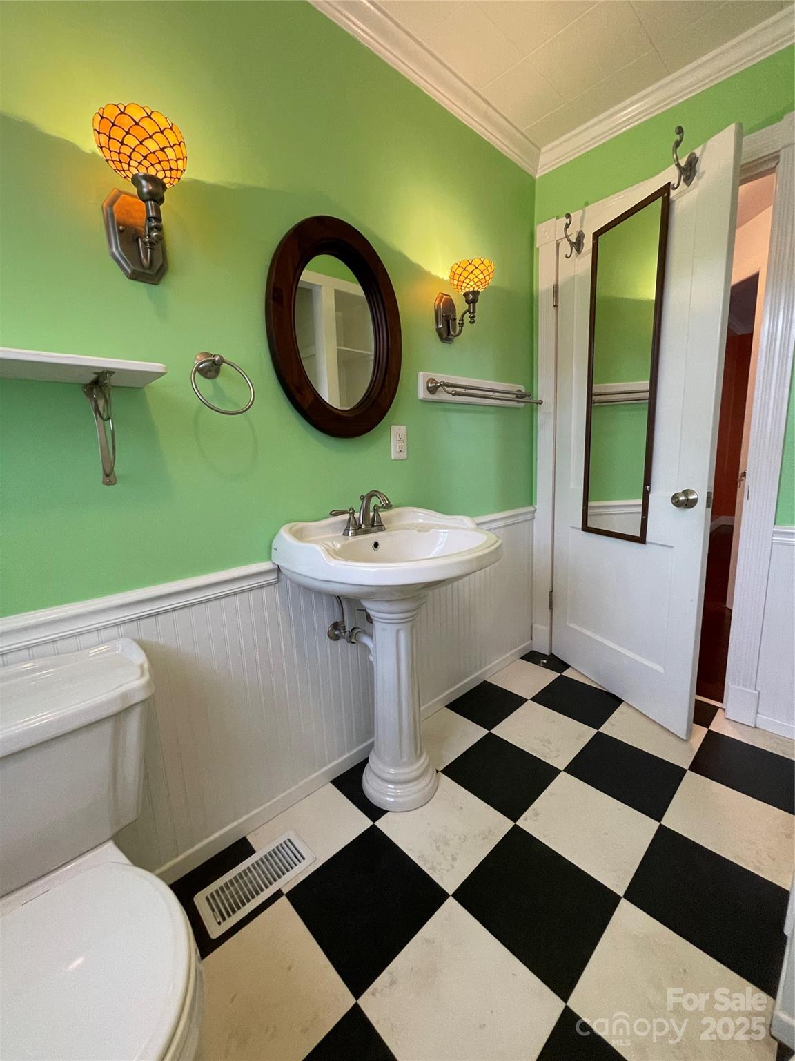 2711 Mooresville Road Salisbury, NC 28147 - Photo 10 of 18 a bathroom with a sink a toilet and a mirror