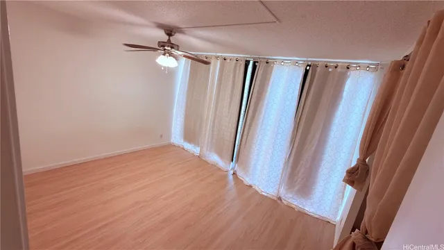 a view of a room with wooden floor and window