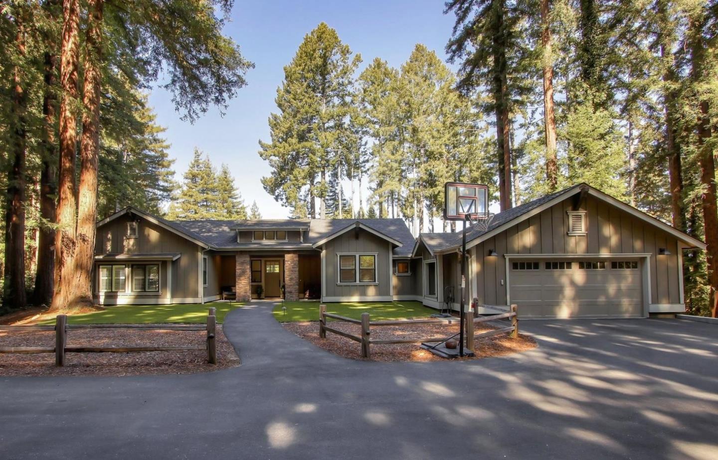 a small house with a bench and trees in the background