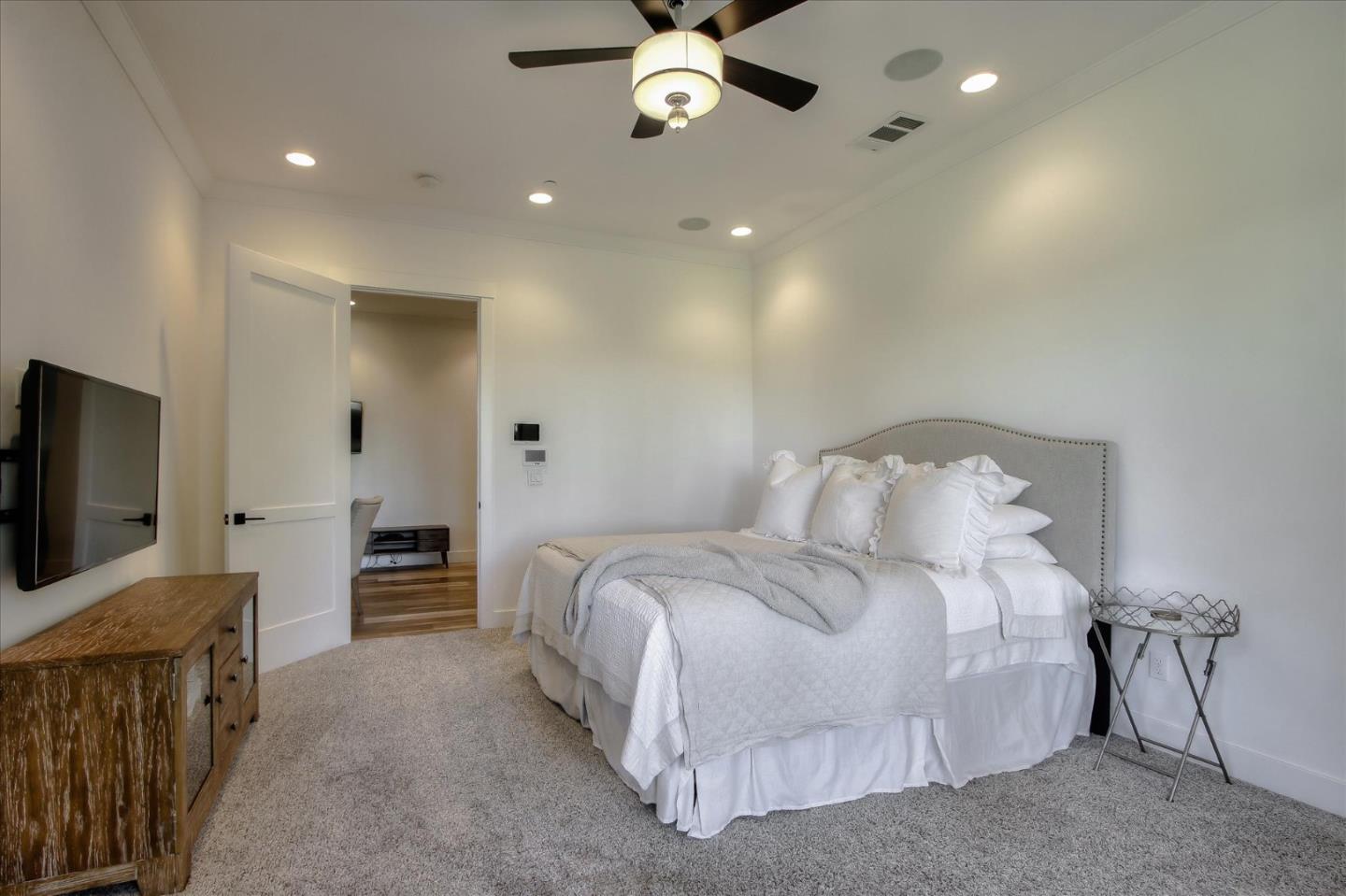 355 McKee Road Felton, CA 95018 - Photo 46 of 71 a spacious bedroom with a bed and a flat screen tv