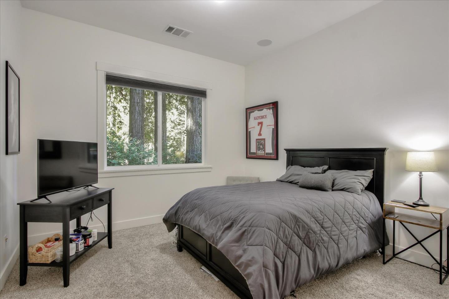 355 McKee Road Felton, CA 95018 - Photo 53 of 71 a bedroom with a bed and a flat screen tv