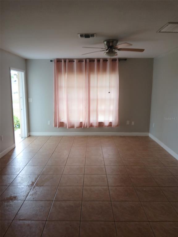 304 Venetia Avenue, Unit A North Port, FL 34287 - Photo 4 of 4 a view of empty room with wooden floor and fan