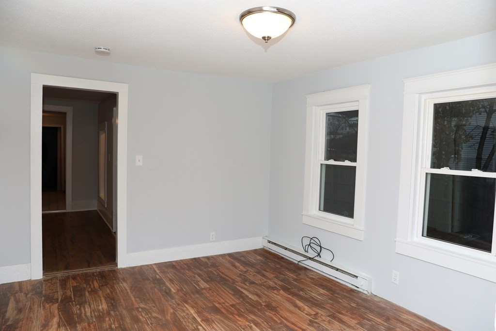 57 Springfield Street Three Rivers, MA 01080 - Photo 11 of 25 wooden floor in an empty room with a window