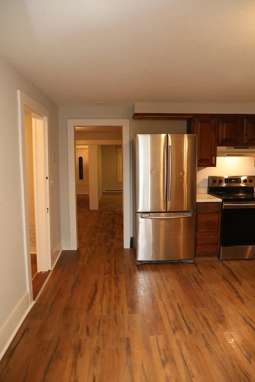 57 Springfield Street Three Rivers, MA 01080 - Photo 4 of 25 a kitchen with stainless steel appliances wooden floor and large window