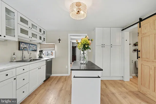 a hallway with sink and wooden floor