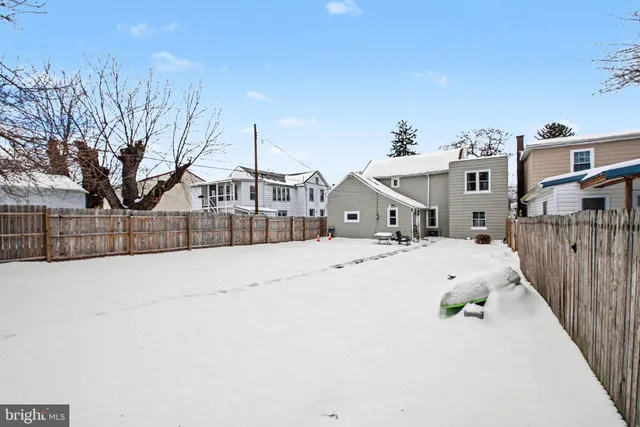 a view of a house with a snow in the background