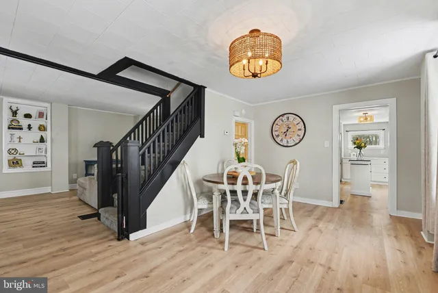 a view of a dining room and hall with wooden floor