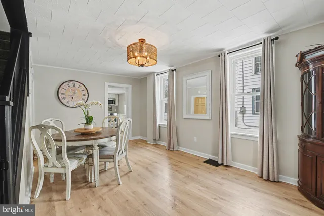 a view of a dining room with furniture and a kitchen view