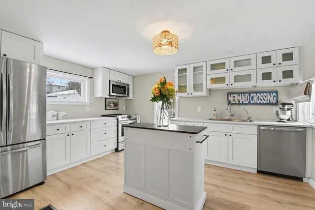a kitchen with stainless steel appliances granite countertop a sink and cabinets
