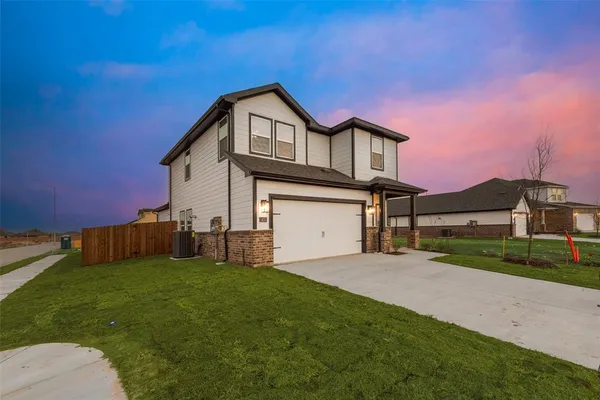 a front view of a house with a yard