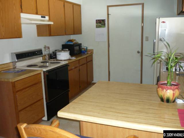 3455 Becard Lane Reno, NV 89508 - Photo 3 of 9 a kitchen with a sink and a refrigerator