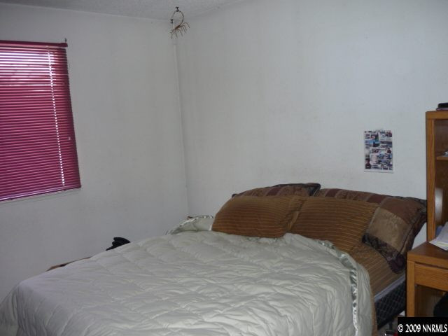 3455 Becard Lane Reno, NV 89508 - Photo 7 of 9 a bedroom with a bed and a window