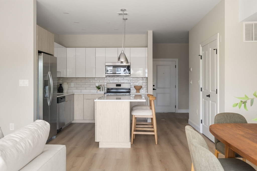 13 Wentworth Road, Unit 404 Quincy, MA 02170 - Photo 6 of 18 a kitchen with a refrigerator and a sink