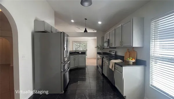 a kitchen with a refrigerator and a sink