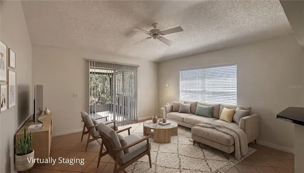 a view of a room with a ceiling fan and a window