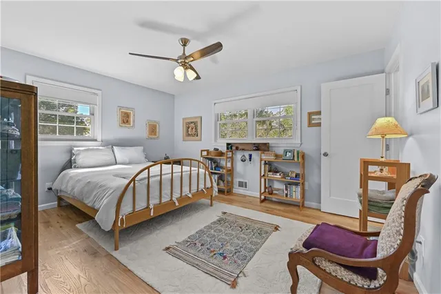 a bedroom with a bed a table and chair