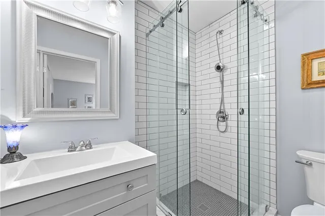 a bathroom with a sink a toilet and shower