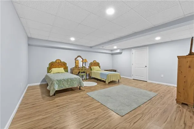 a spacious bedroom with a bed and a table in it