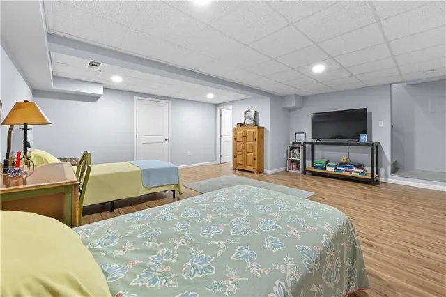 a bedroom with furniture and a flat screen tv