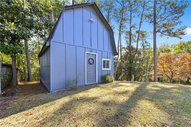 a view of a backyard with potted plants and large tree