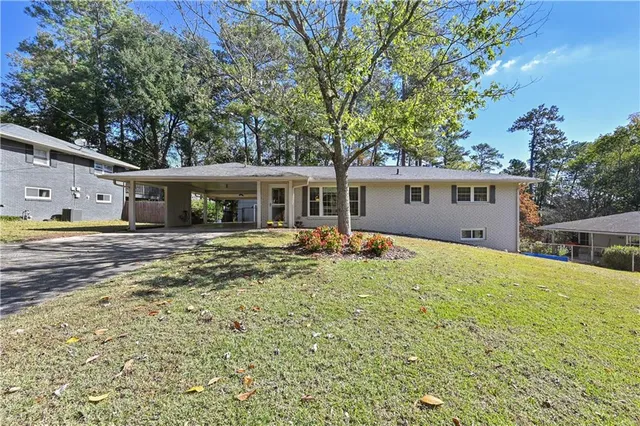 a view of a house with swimming pool and a yard