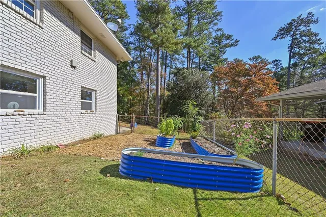 a backyard of a house with fountain table and chairs