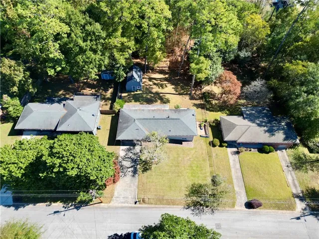 an aerial view of a house with a yard basket ball court and outdoor seating