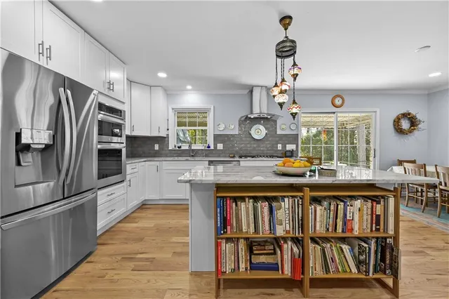 a kitchen with cabinets and stainless steel appliances